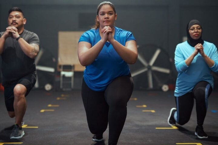 Three people performing lunges