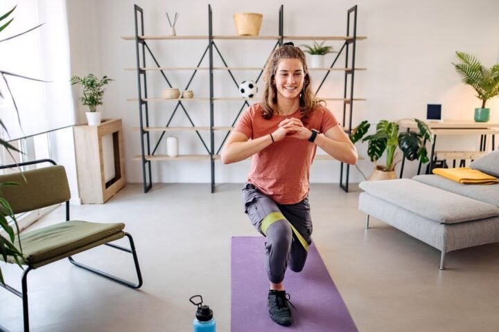 Woman performs lunge with a resistance band
