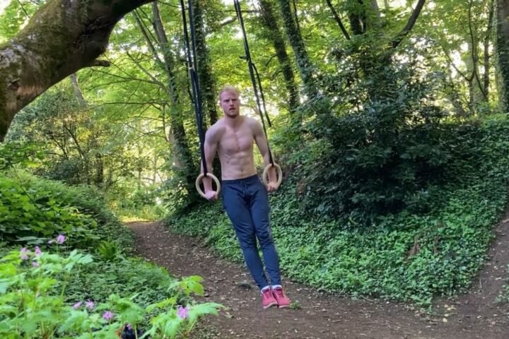 Harry Bullmore using gym rings in a forest